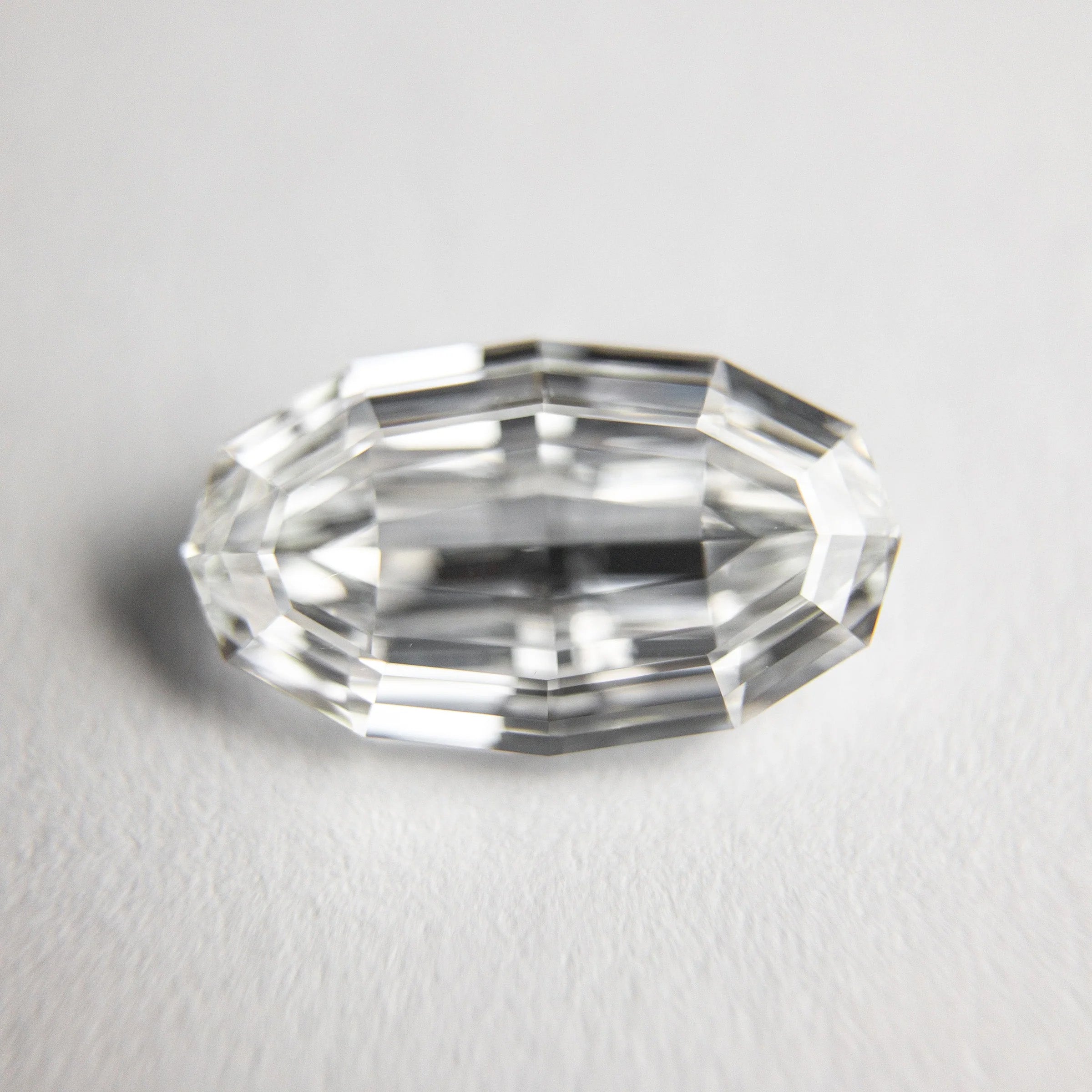 Oval step cut diamond featuring elongated facets and an elegant oval shape